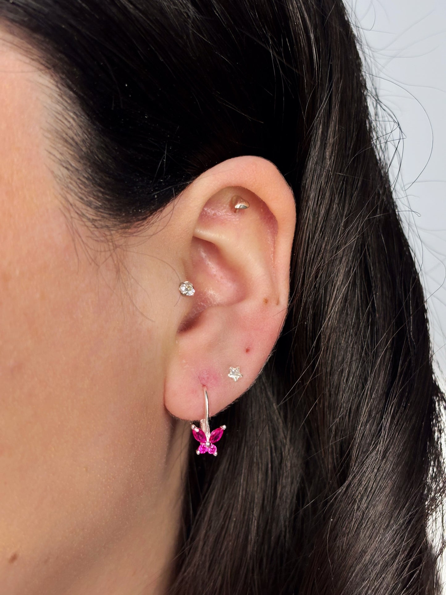 Aros mariposa circón fucsia